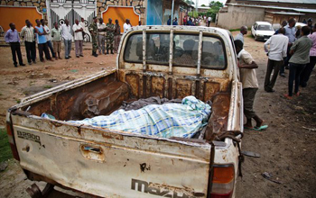 The body of a domestic worker who was shot by the police lay in the back of a truck in Musaga, a neighborhood of Bujumbura, the capital, in January. GRIFF TAPPER / AGENCE FRANCE-PRESSE — GETTY IMAGES